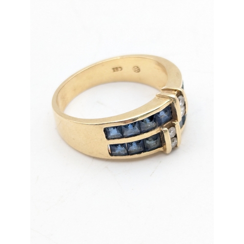 43 - A 14ct yellow gold ring with channel set sapphires and four bar set diamonds, size N1/2, weight 4.9g... 