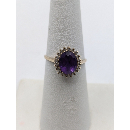 54 - Two 9ct yellow gold rings to include an amethyst and diamond cluster ring size N1/2 and a heart shap... 