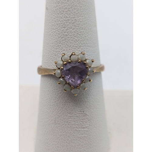 54 - Two 9ct yellow gold rings to include an amethyst and diamond cluster ring size N1/2 and a heart shap... 