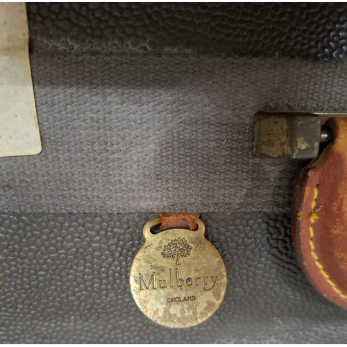 9 - Mulberry- A vintage suitcase in mole Scotchgrain and tan saddle leather trim and handles with wheels... 
