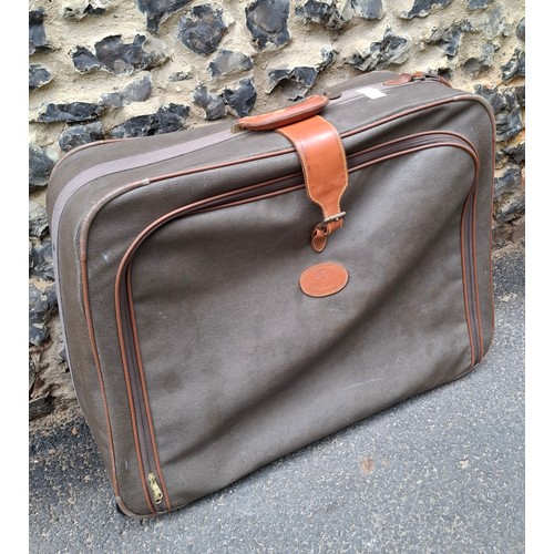 9 - Mulberry- A vintage suitcase in mole Scotchgrain and tan saddle leather trim and handles with wheels... 