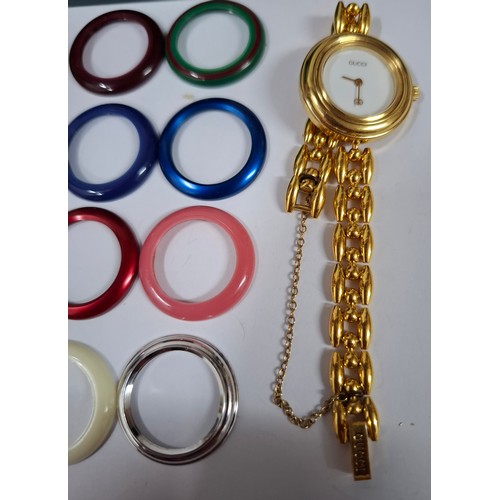 10 - Gucci- A ladies gold tone interchangeable occasional watch 0202951 having a safety chain with brande... 