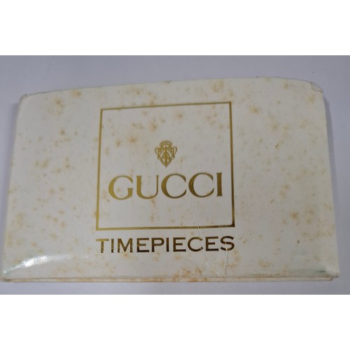 10 - Gucci- A ladies gold tone interchangeable occasional watch 0202951 having a safety chain with brande... 