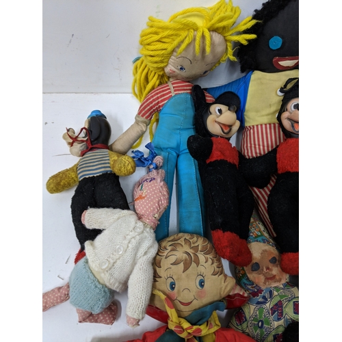 12 - Assorted soft toys and bears to include Golly dolls, a pull along dog on a bike, soft toys some fash... 