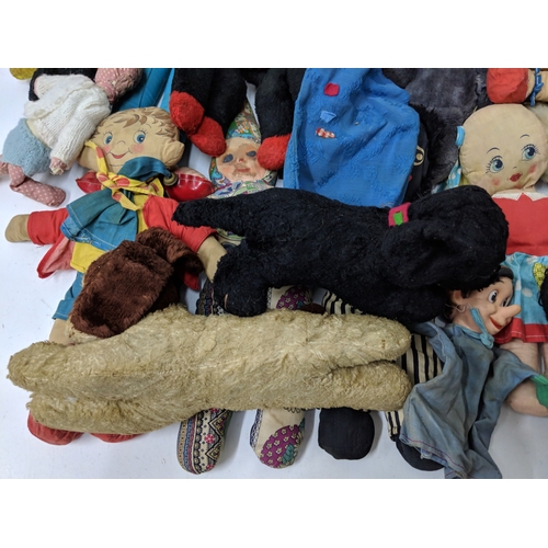 12 - Assorted soft toys and bears to include Golly dolls, a pull along dog on a bike, soft toys some fash... 