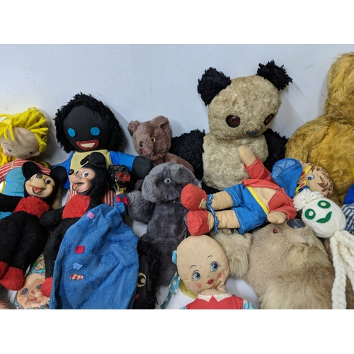 12 - Assorted soft toys and bears to include Golly dolls, a pull along dog on a bike, soft toys some fash... 
