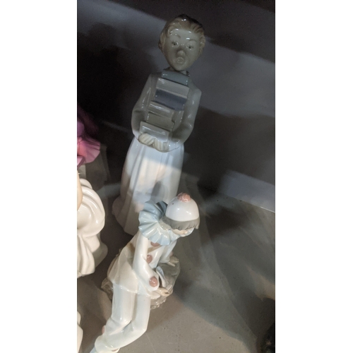 35 - A collection of porcelain figures to include a Lladro clown playing a saxophone, a Royal Doulton Tra... 