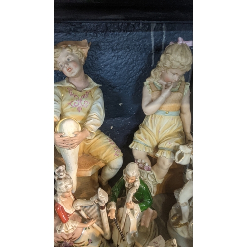 43 - A group of ceramic figures to include an early 20th century Chinese example of a man with a monkey o... 