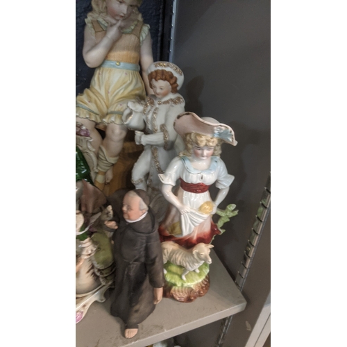 43 - A group of ceramic figures to include an early 20th century Chinese example of a man with a monkey o... 
