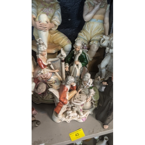 43 - A group of ceramic figures to include an early 20th century Chinese example of a man with a monkey o... 