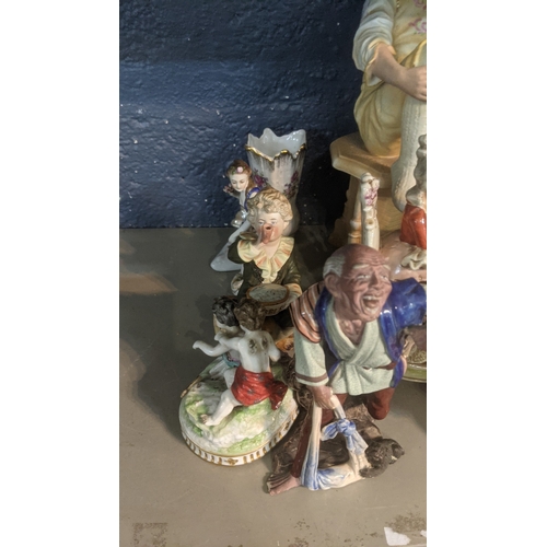 43 - A group of ceramic figures to include an early 20th century Chinese example of a man with a monkey o... 