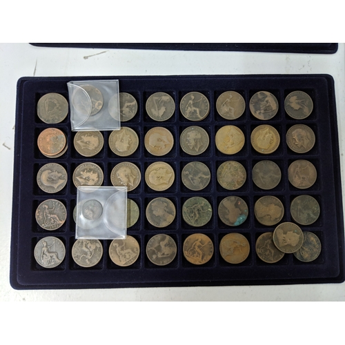 9 - Assorted coins, all British and displayed in coin trays to include pennies, five pence, two shilling... 