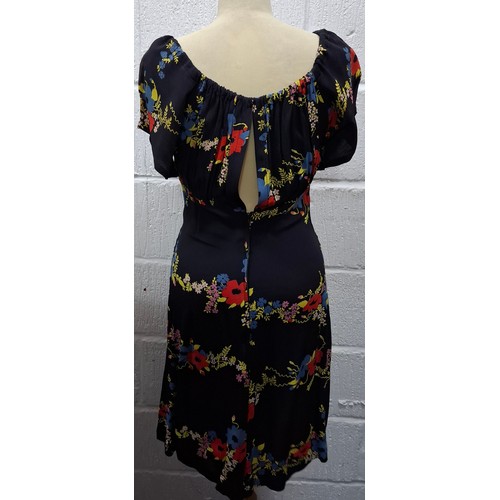 12 - Ossie Clark- A 1970's black knee length Summer dress supplied for Radley having a blue and red poppy... 