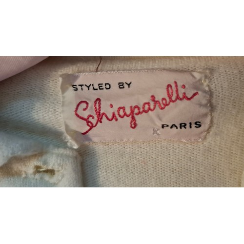 27 - Schiaparelle & Frank Usher- A white Schiaparelle cardigan with crystal buttons and accents having 4 ... 