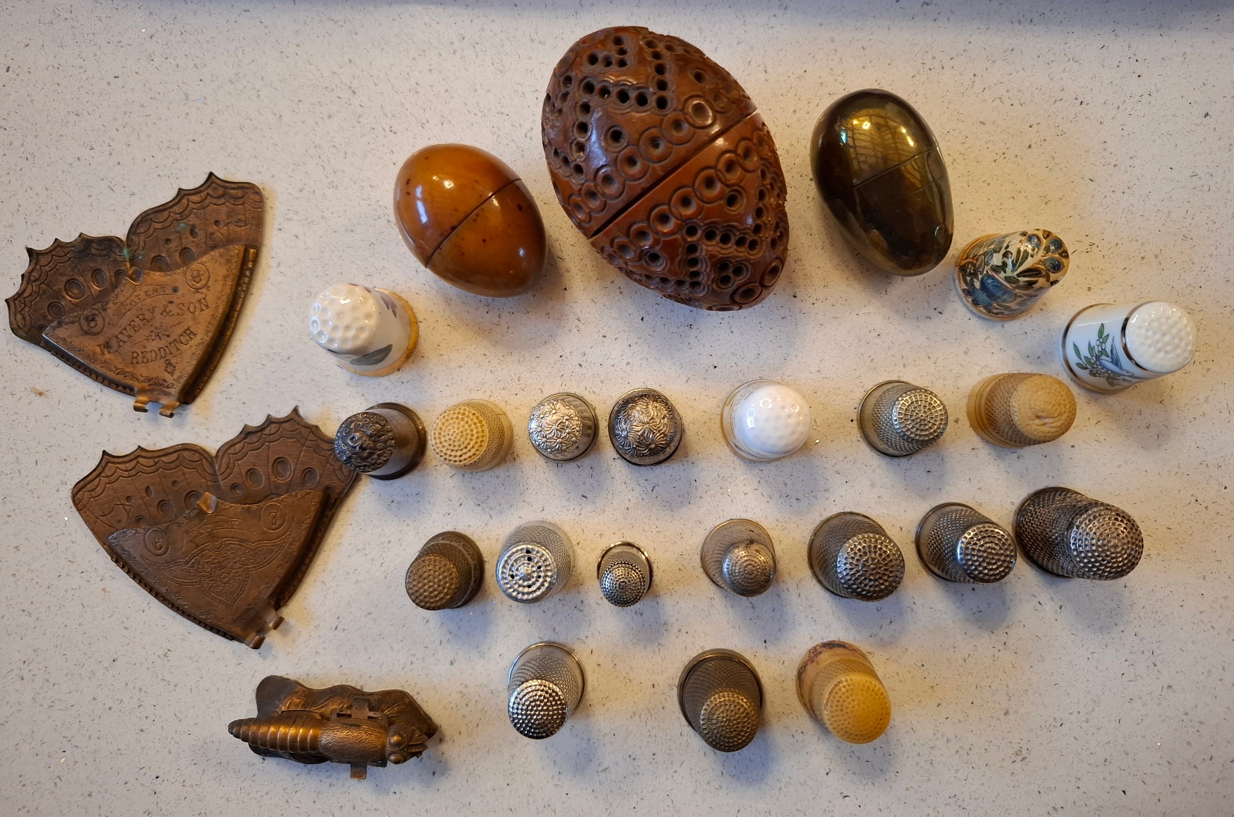 A collection of thimbles, thimble cases, a Victorian carved coquilla ...