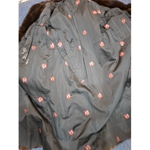 32 - A 1980's very dark brown mink fur coat, appears black in certain lighting, having a black toggle tie... 