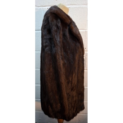 31 - A vintage glossy brown mink fur coat having flared sleeves and side pockets approx 38