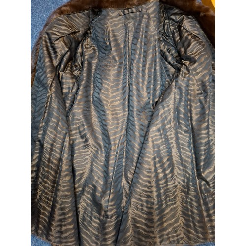 31 - A vintage glossy brown mink fur coat having flared sleeves and side pockets approx 38
