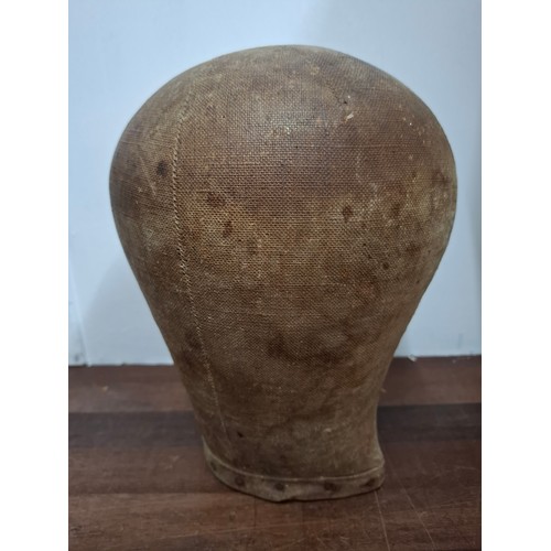 13 - An early 20th Century cloth covered wooden milliners head with metal studs to base. Location: R2.1
I... 