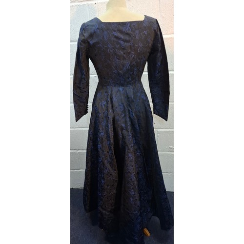 34 - A mid 20th Century blue brocade full length dress with gathered skirt and button cuffs, approx 32/34... 