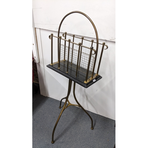 An early 20th century brass and black lacquered revolving magazine rack ...