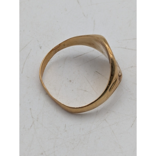 24 - A yellow metal signet ring with engraved initials tested as 9ct gold, weight 2.9g
Location: R1
If th... 