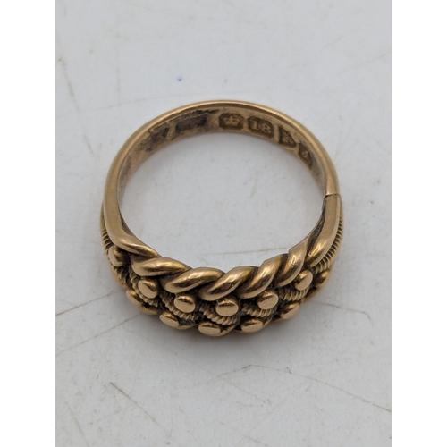 31 - An 18ct yellow gold keeper ring with woven design, stamped 18ct, with British hallmarks, size I 1/2,... 