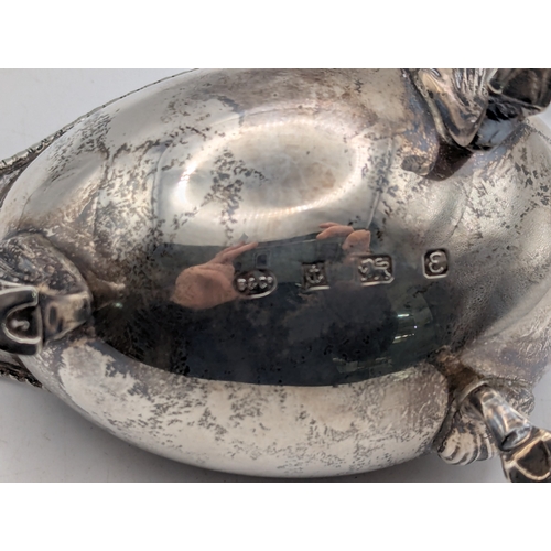 34 - A silver sauce boat with beaded rim and scroll handle on three feet hallmarked Birmingham 1979, weig... 
