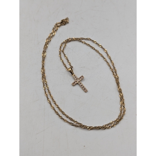 48 - A 9ct yellow gold fancy link necklace with cross pendant set with paste stones, weight 2.4g
Location... 