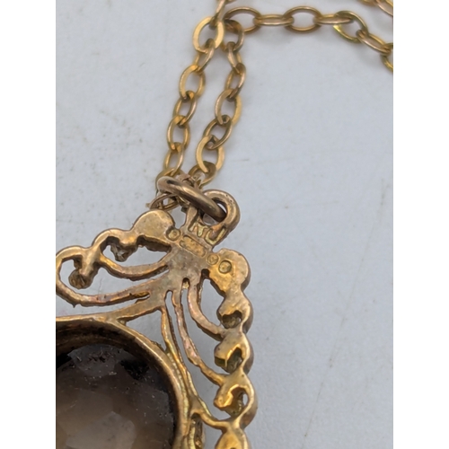 51 - A 9ct yellow gold teardrop shaped pendant with claw set oval faceted cut smoky quartz on a fine 9ct ... 