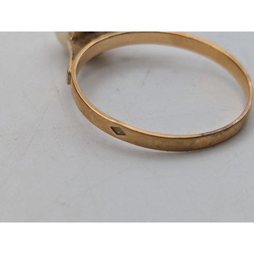 52 - A yellow metal and pearl solitaire ring tested as 18ct yellow gold, size M1/2 weight 1.4g together w... 