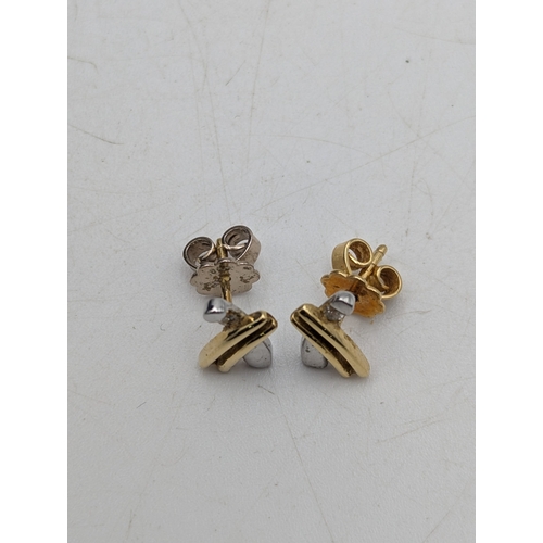 6 - A pair of 18ct gold tri-coloured earrings each set with a small diamond stamped 750, weight 2.7g
Loc... 
