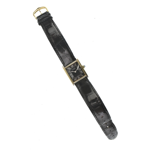 21 - A Cartier Tank Must, manual wind, ladies silver gilt wristwatch, circa 1984, the black dial with whi... 