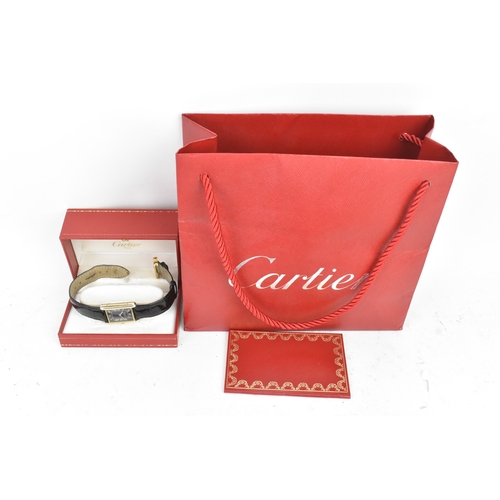 21 - A Cartier Tank Must, manual wind, ladies silver gilt wristwatch, circa 1984, the black dial with whi... 