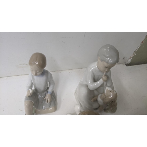 45 - A group of six Lladro Spanish porcelain figures to include 'Boy with Dog', 'Girl with a Flower', and... 