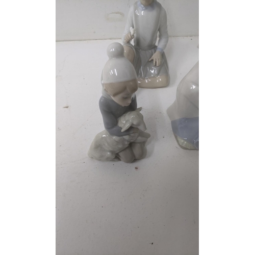 45 - A group of six Lladro Spanish porcelain figures to include 'Boy with Dog', 'Girl with a Flower', and... 