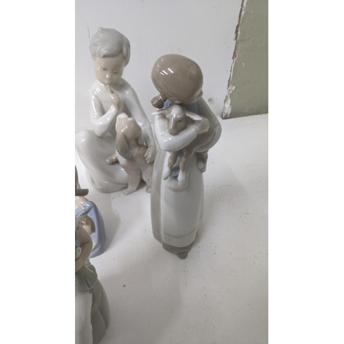 45 - A group of six Lladro Spanish porcelain figures to include 'Boy with Dog', 'Girl with a Flower', and... 
