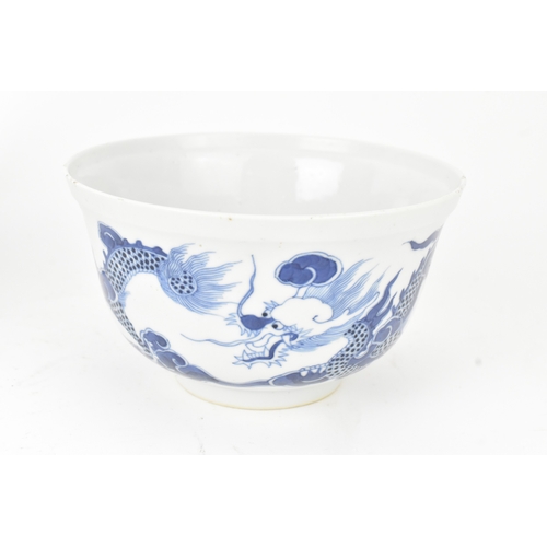 38 - A group of four Chinese and Japanese blue and white porcelain items, comprising: a dragon bowl paint... 