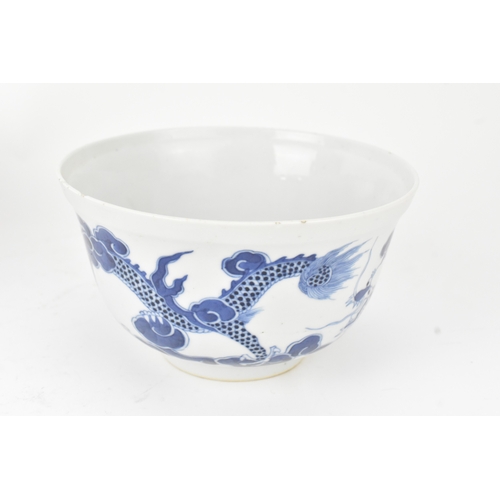 38 - A group of four Chinese and Japanese blue and white porcelain items, comprising: a dragon bowl paint... 