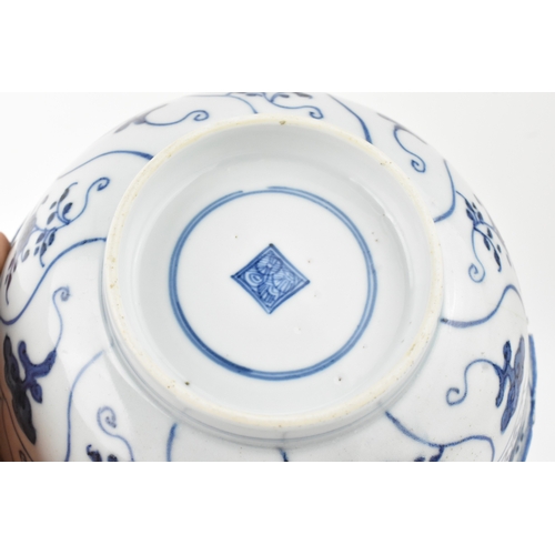 38 - A group of four Chinese and Japanese blue and white porcelain items, comprising: a dragon bowl paint... 