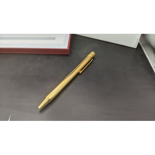 10 - A boxed cartier Santos Sans a Graffe gold plated ballpoint pen with certificate and user guide
Locat... 