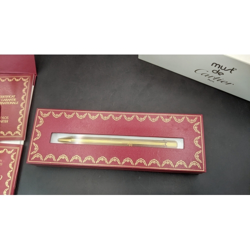 10 - A boxed cartier Santos Sans a Graffe gold plated ballpoint pen with certificate and user guide
Locat... 