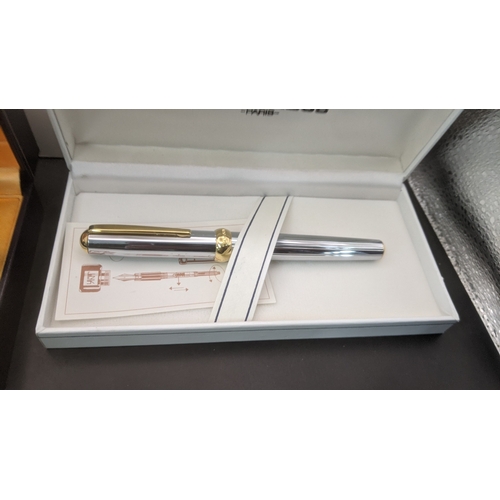 11 - Boxed pens to include a black cased Waterman ideal fountain pen with an 18ct gold nib along with a s... 