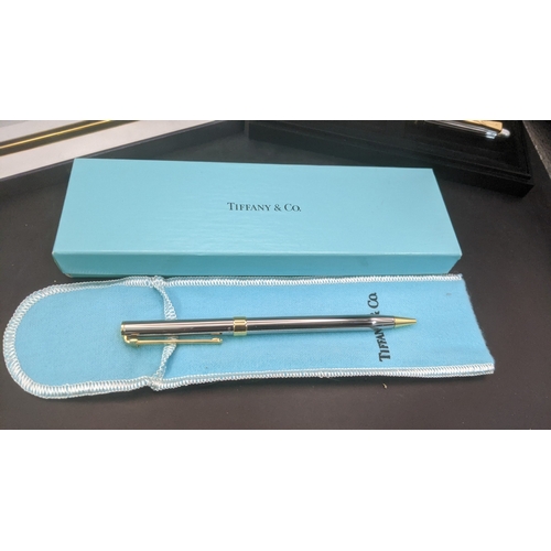 12 - Boxed writing equipment to include a Caran D'ache gold plated ballpoint pen, an Yves Saint Laurent c... 