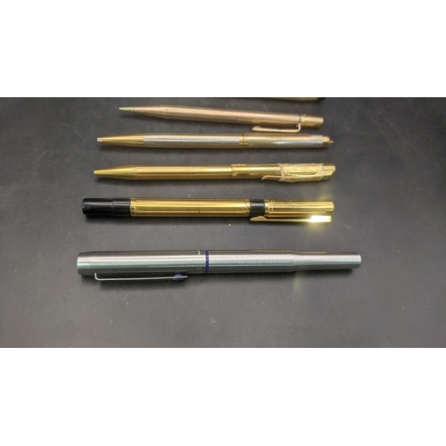 13 - A collection of unboxed writing equipment to include three gold plated Cross ballpoint pens, a burgu... 