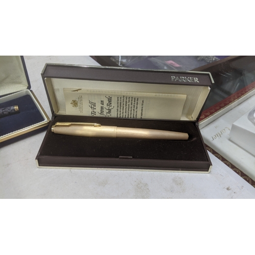 14 - Boxed pens to include a stainless steel Sheaffer fountain pen with a 14k gold nib, a gold coloured c... 
