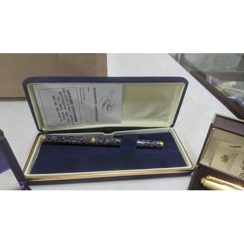 14 - Boxed pens to include a stainless steel Sheaffer fountain pen with a 14k gold nib, a gold coloured c... 