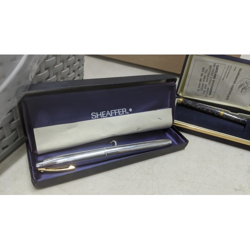 14 - Boxed pens to include a stainless steel Sheaffer fountain pen with a 14k gold nib, a gold coloured c... 