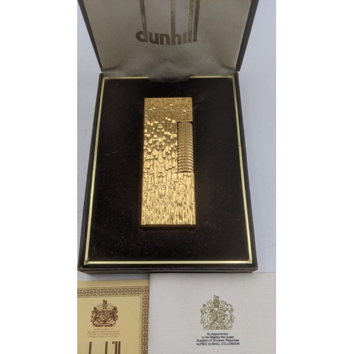 25 - Boxed cigarette lighters to include a gold plated Dunhill Rollagas lighter along with a silver plate... 