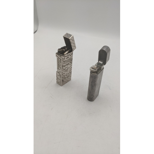 28 - A pair of cigarette lighters to include a silver plated Cartier along with a Dunhill Palladium with ... 
